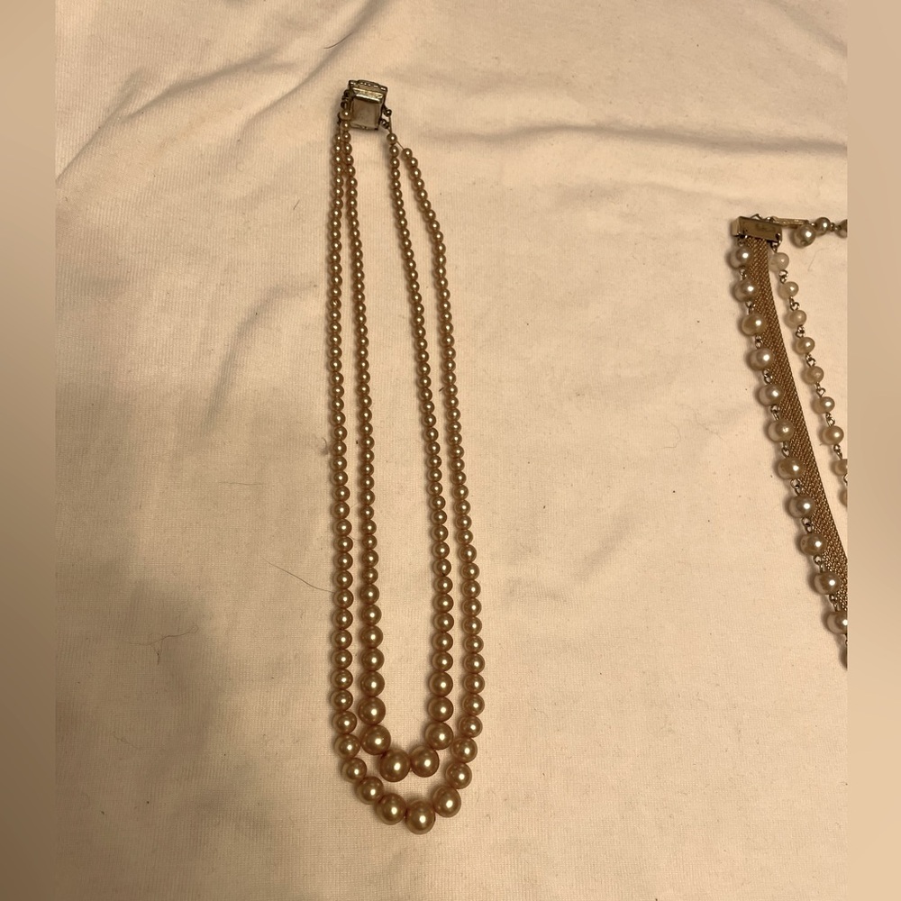 Two vintage pearl necklaces and a matching bracelet.